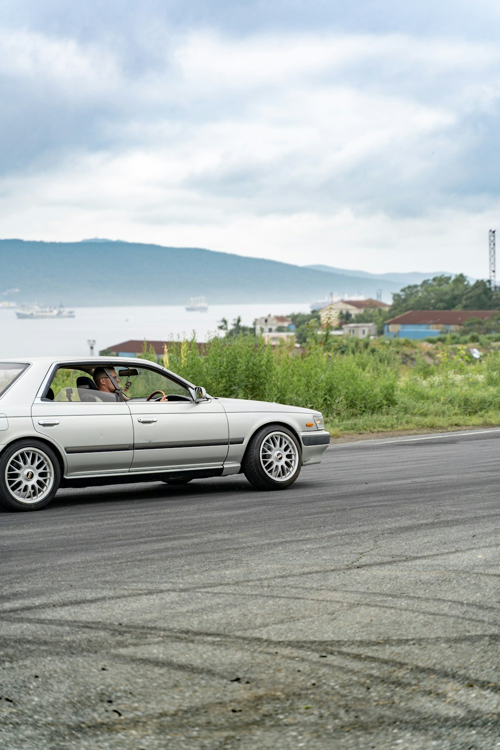 white coupe on road during daytime