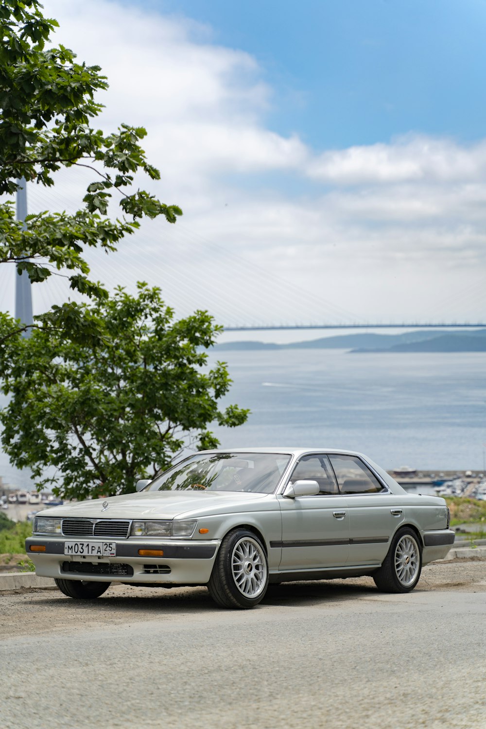 white mercedes benz coupe parked near body of water during daytime