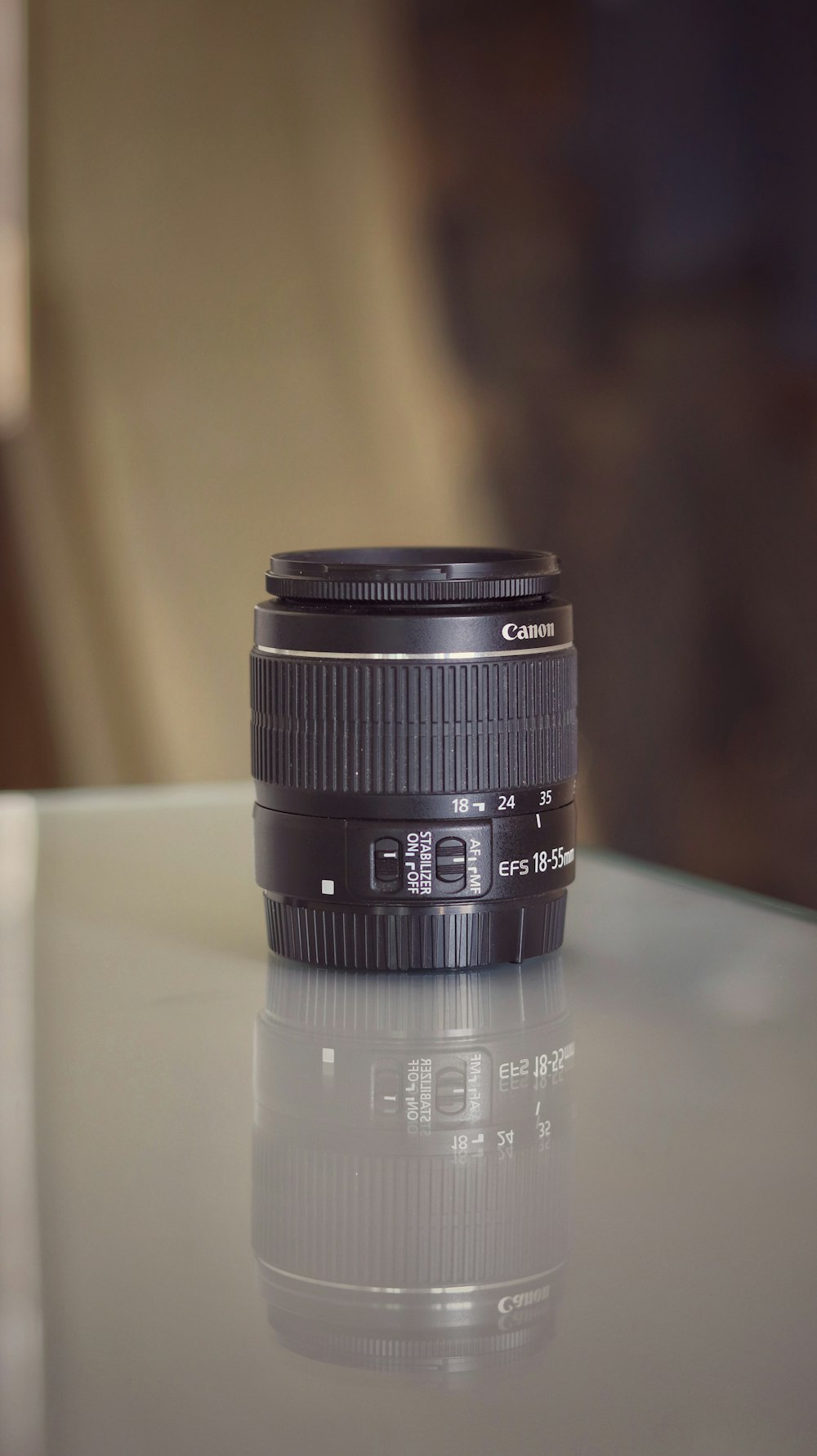 black camera lens on white table