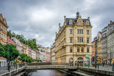 brown concrete building near bridge under white sky during daytime