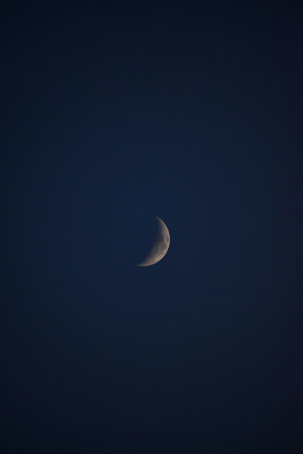 white crescent moon in the sky
