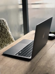 macbook pro on brown wooden table