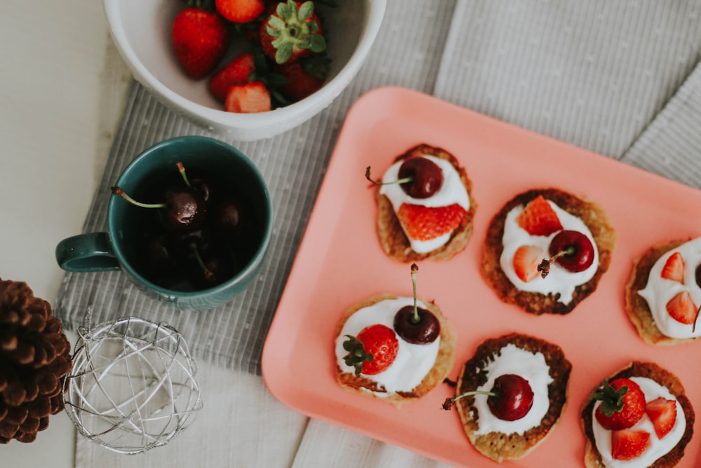 red and black fruit on white ceramic tray