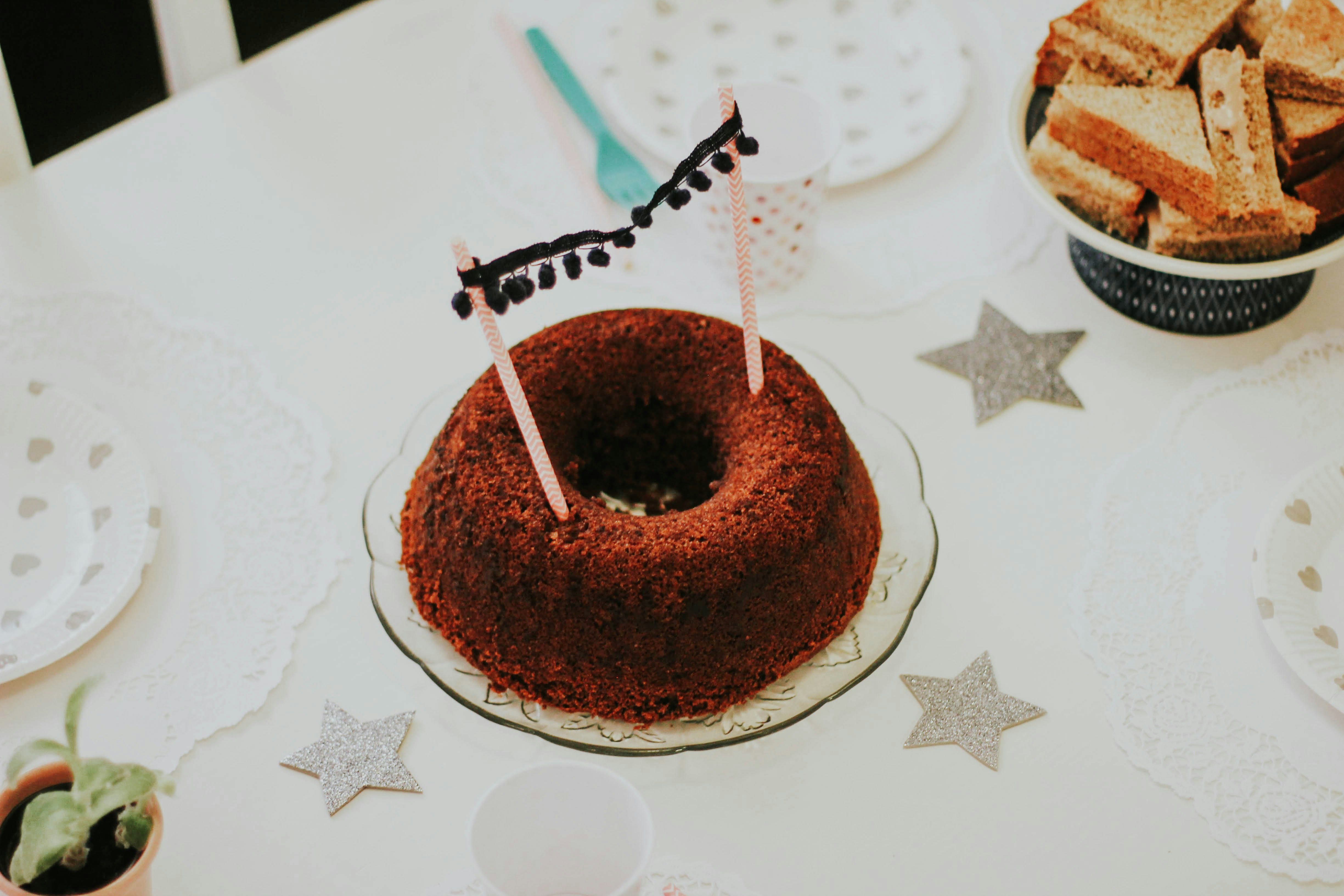 chocolate cake with white and green star on white and gray floral table cloth