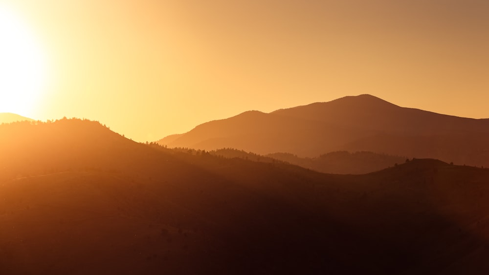 silhouette of mountains during sunset