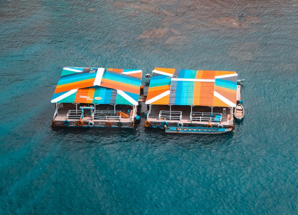 red blue and white boat on body of water during daytime