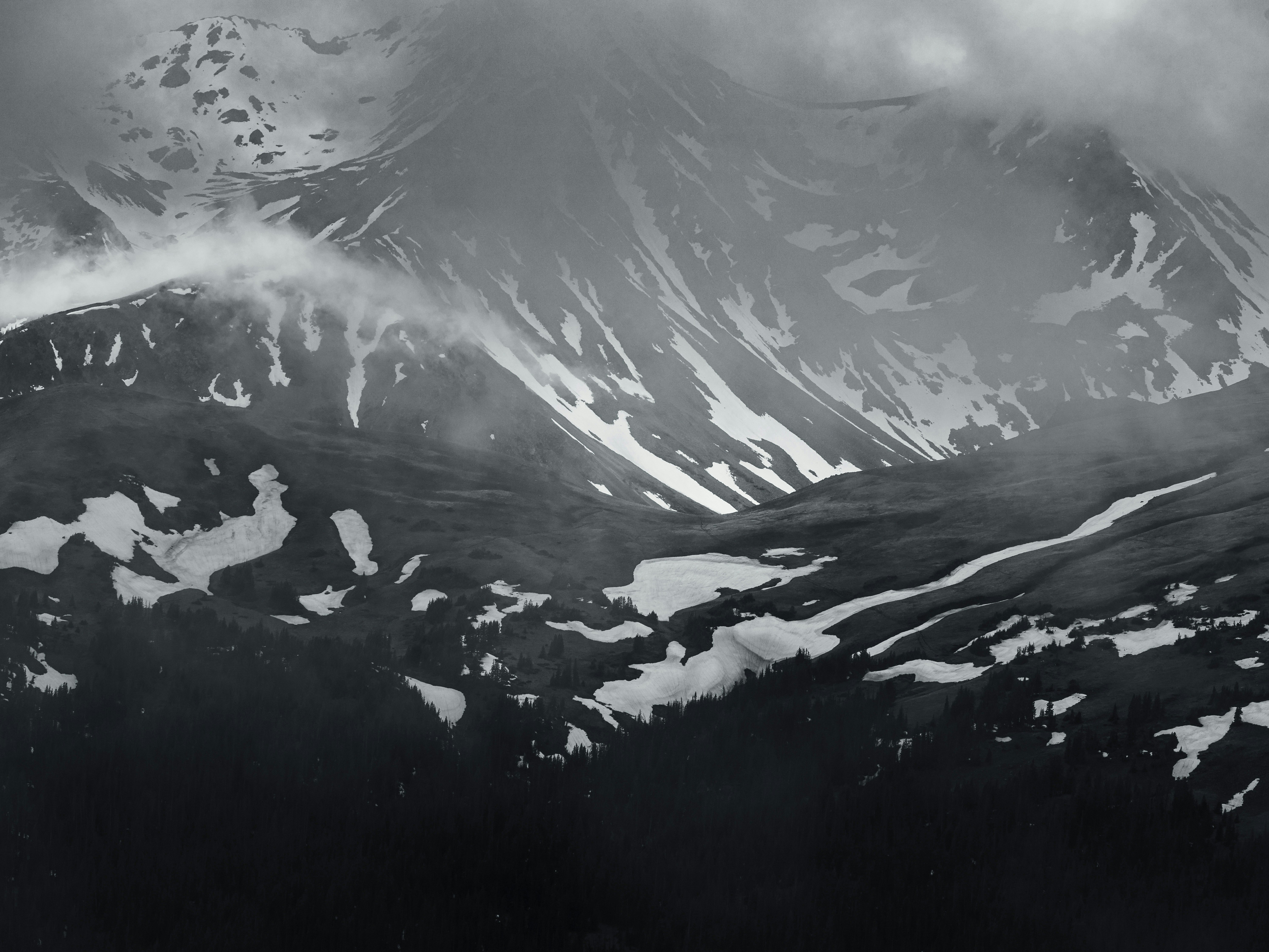 grayscale photo of mountains covered with snow