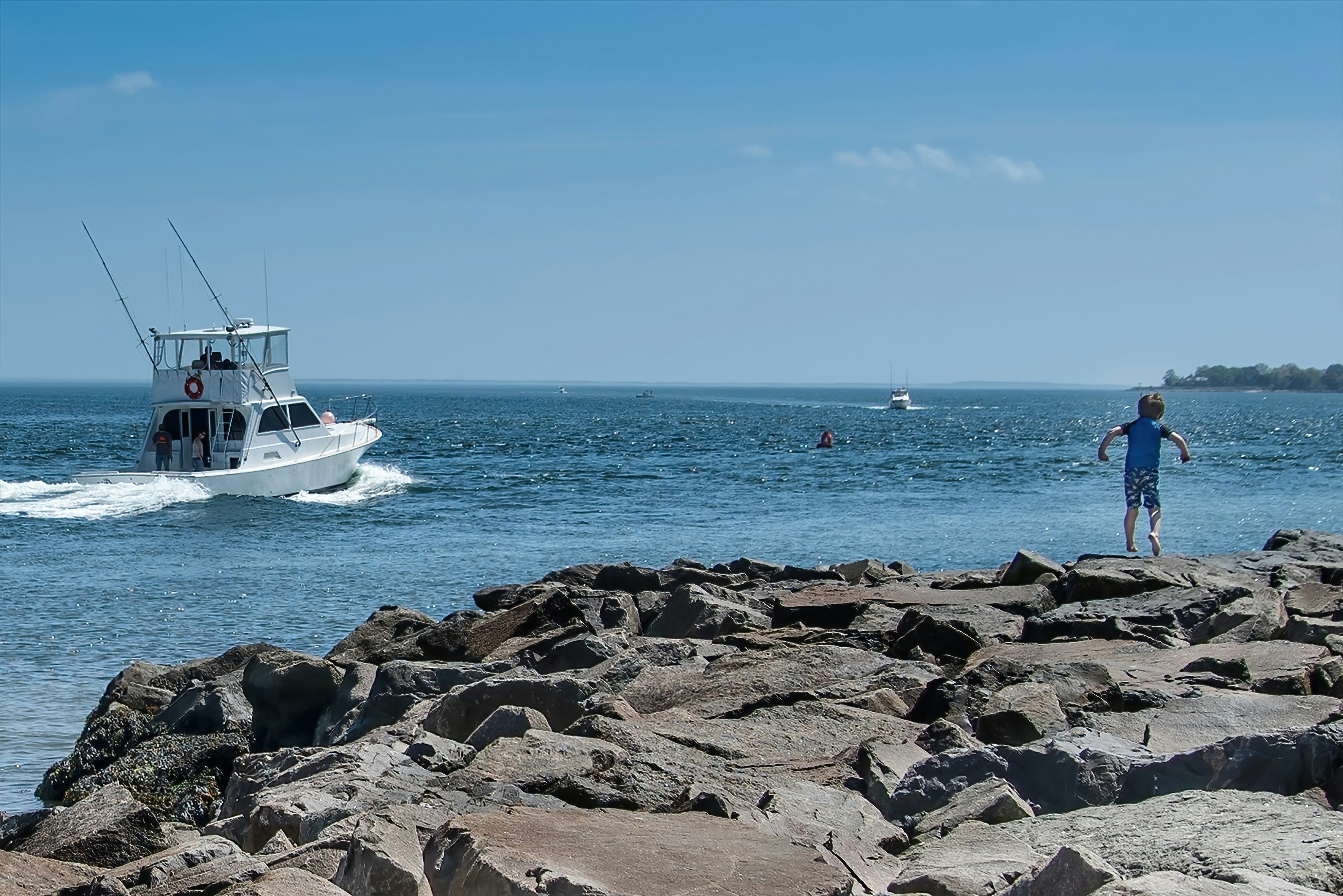 white boat on sea shore during daytime
