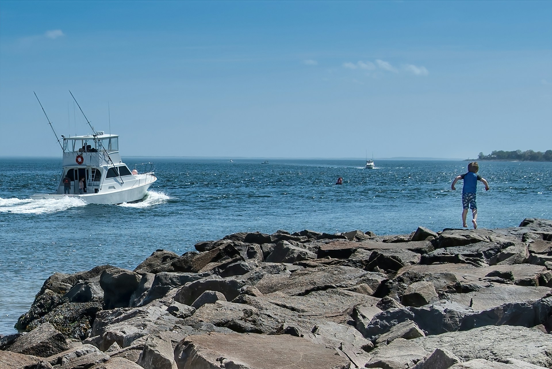 white boat on sea shore during daytime