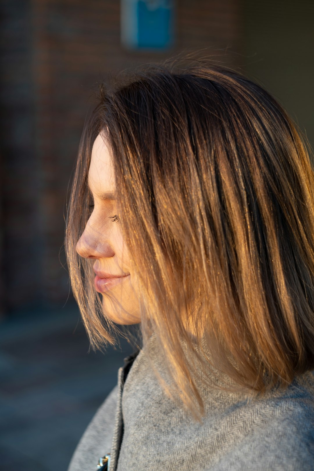 woman in gray shirt looking down