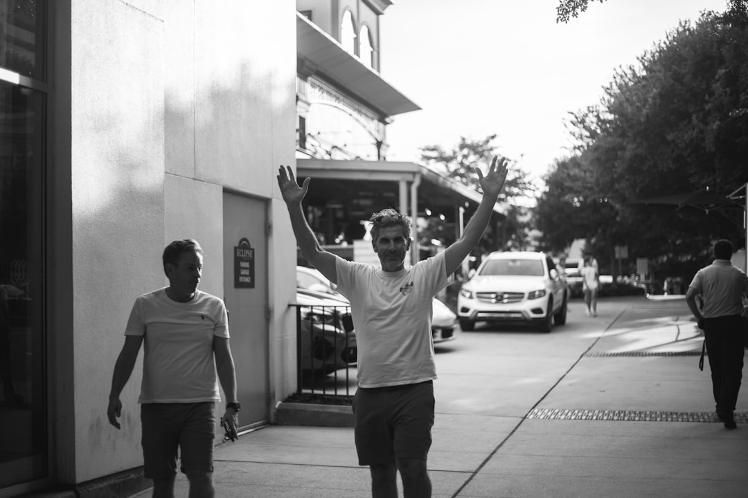 grayscale photo of man in white t-shirt and black shorts