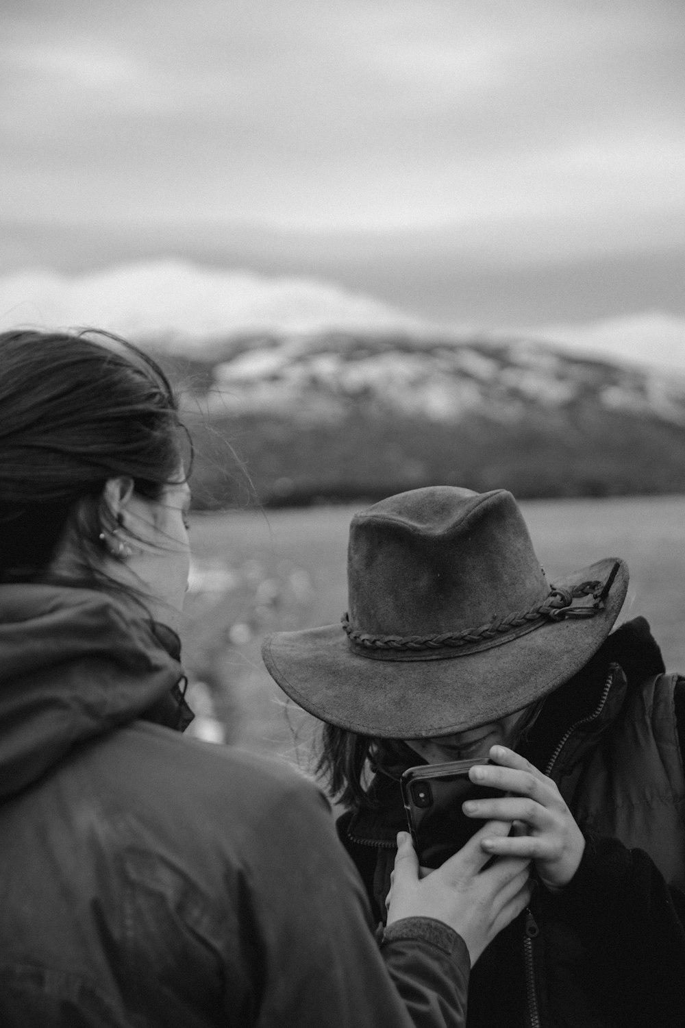 grayscale photo of woman in black hat and jacket