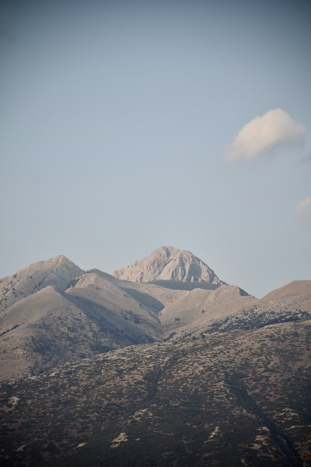 brown and white mountains under white sky during daytime