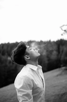 A peaceful morning scene with a person breathing fresh air outside, symbolizing freedom from smoking.