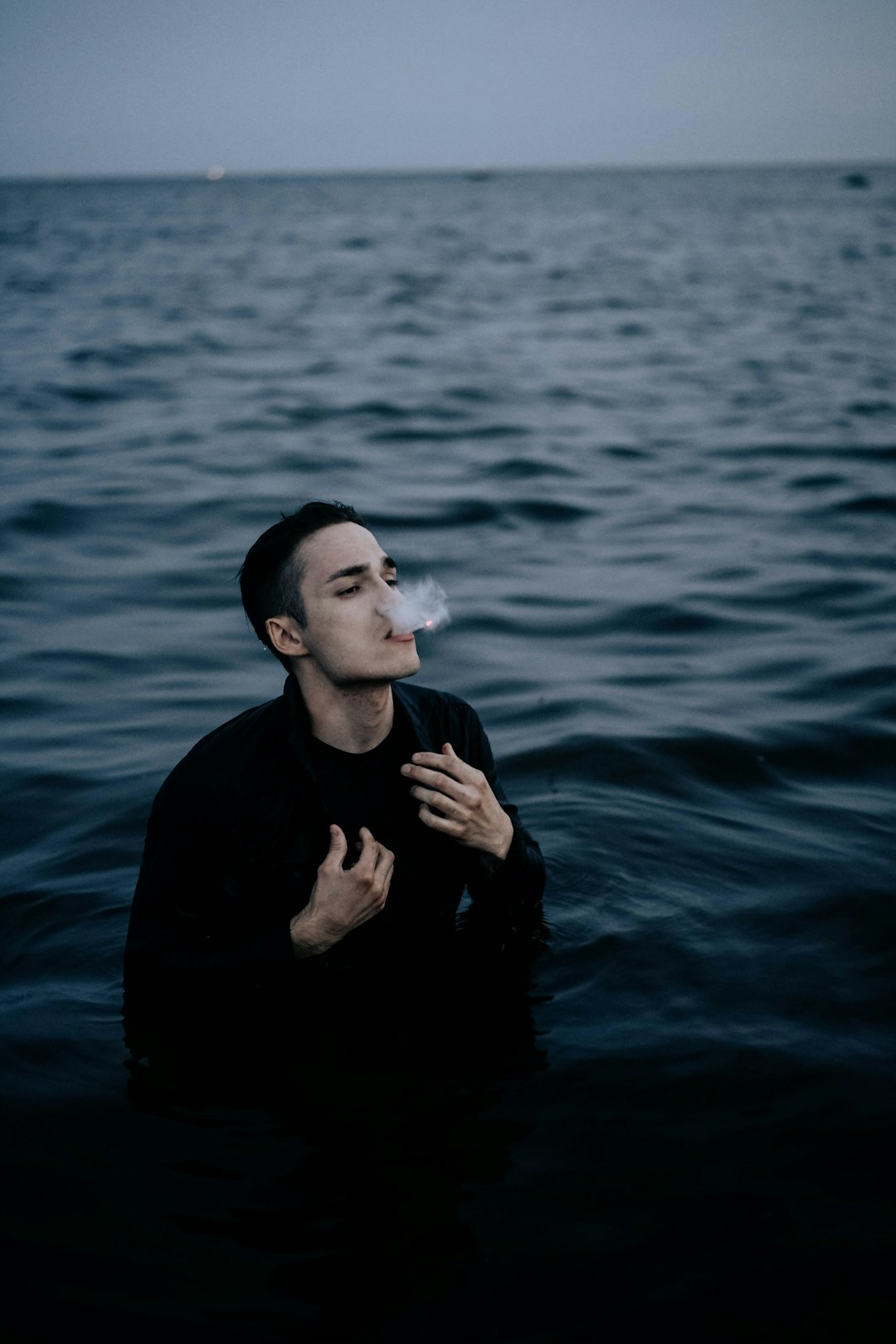 man in black long sleeve shirt in water