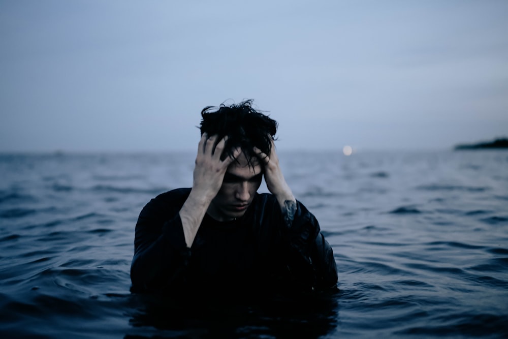 man in black jacket on water