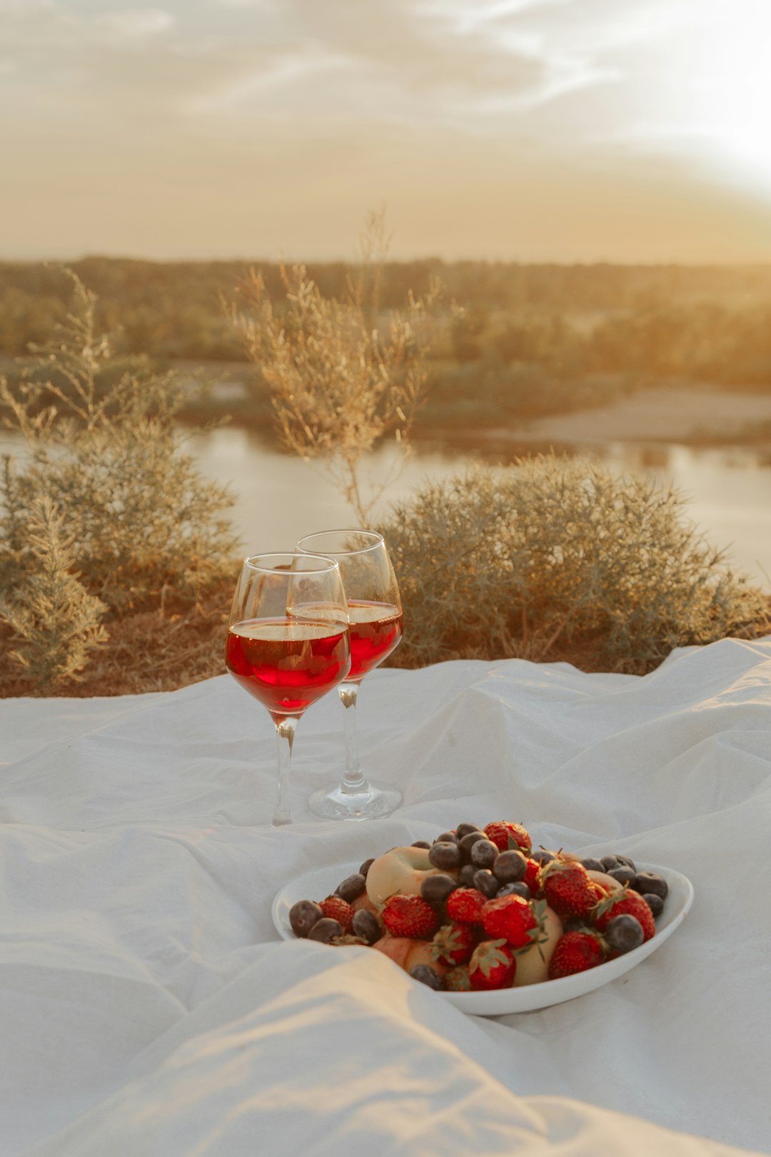 red wine in clear wine glass on white textile