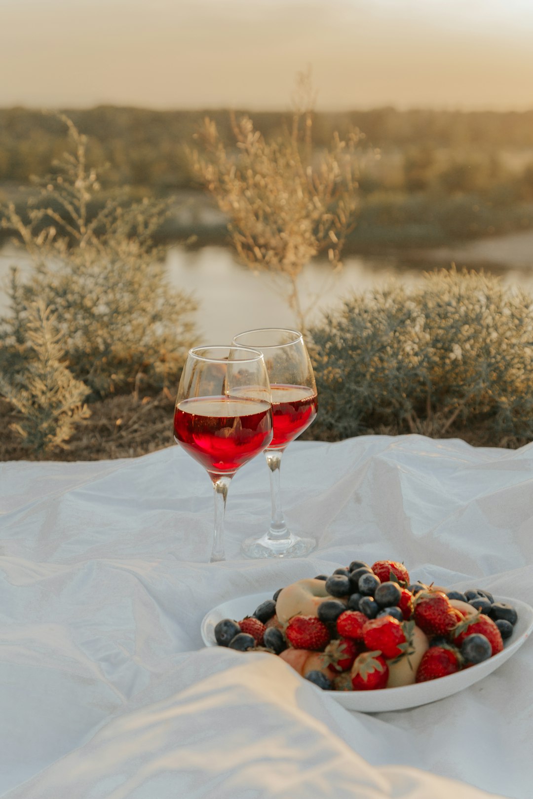 red wine in clear wine glass on white textile