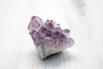 purple crystal on white table