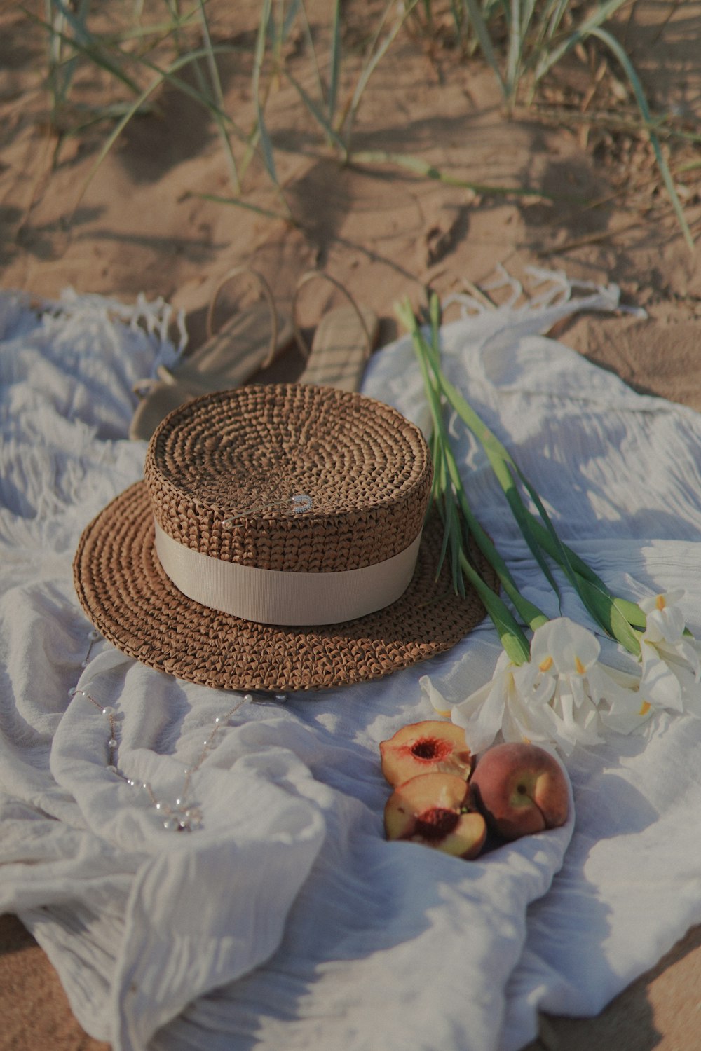 brown and white round hat on white and blue floral textile