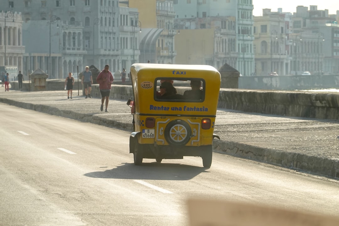 yellow and black auto rickshaw on road during daytime