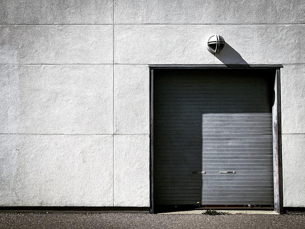 porta in legno nero su parete di cemento grigio