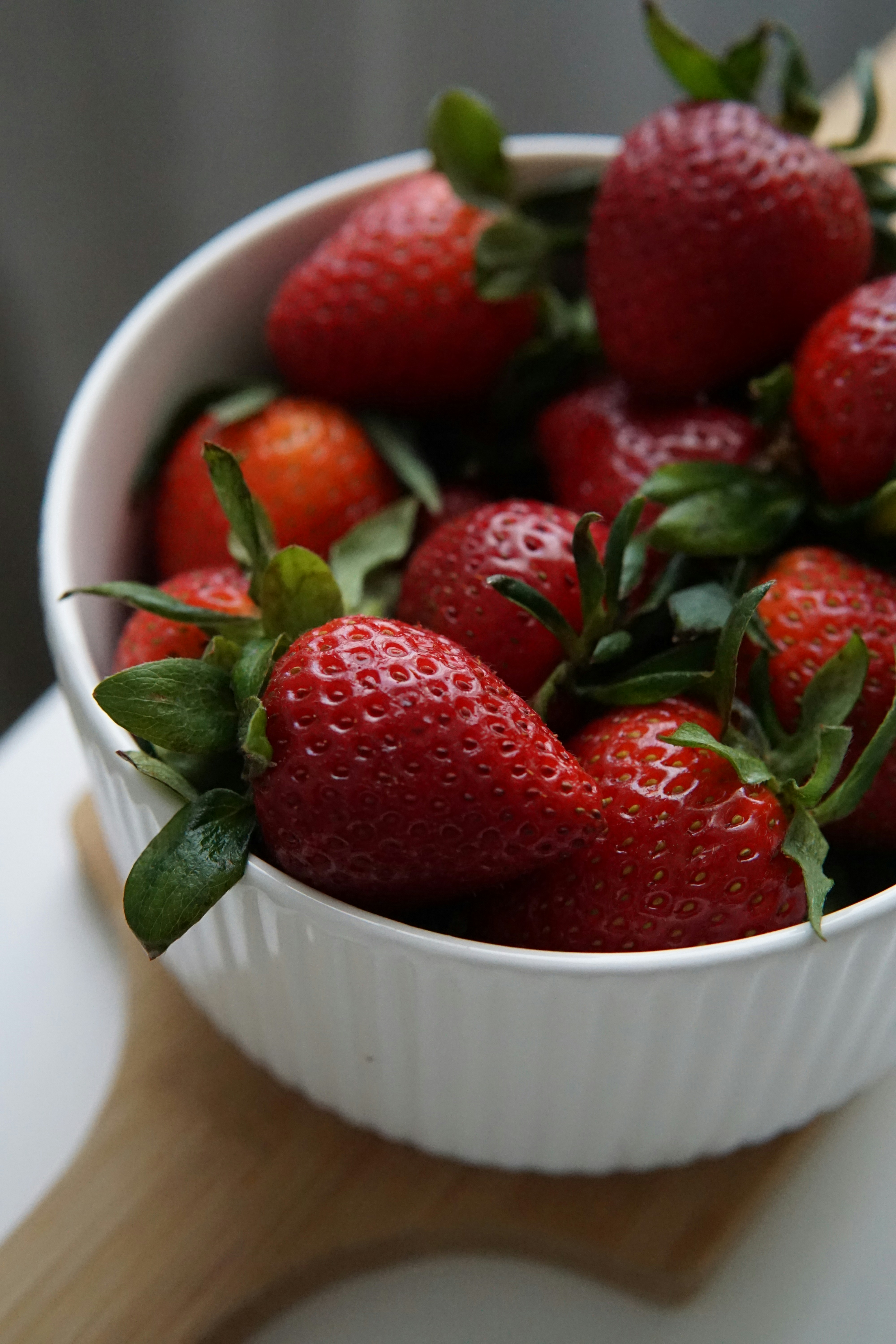 strawberries in white ceramic bowl
