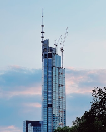 A sleek, modern construction site silhouette against a clear sky background.