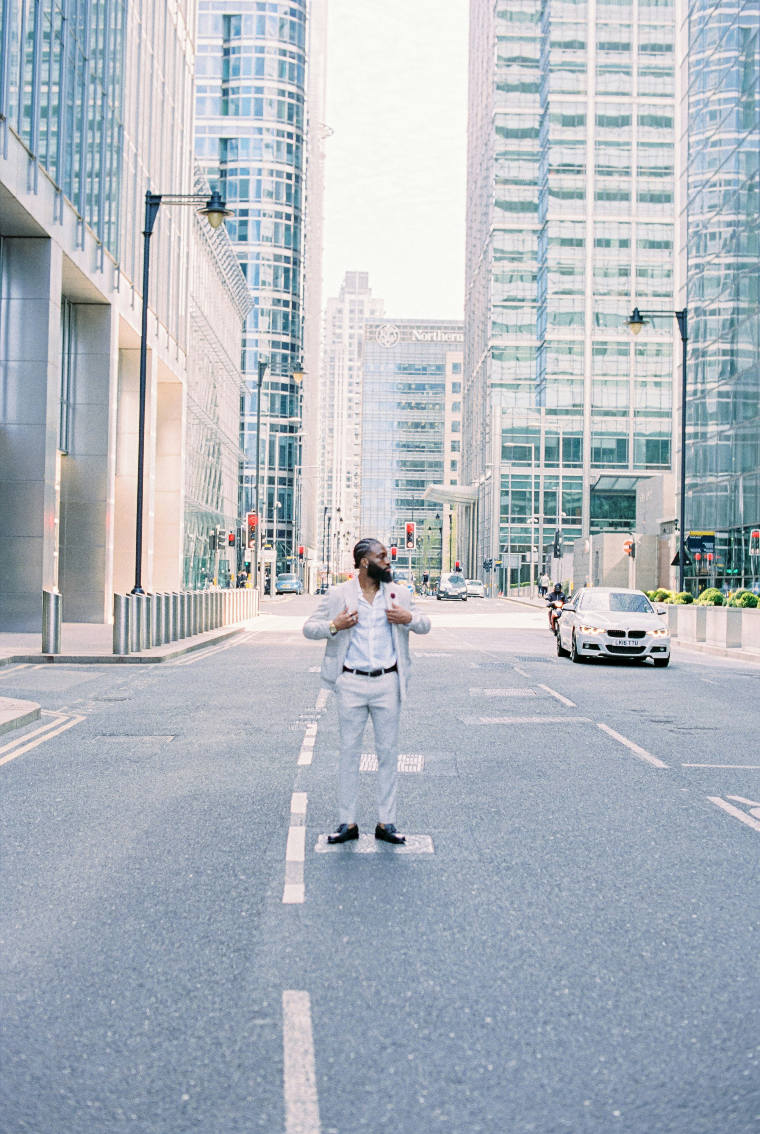 woman in white jacket standing on road during daytime