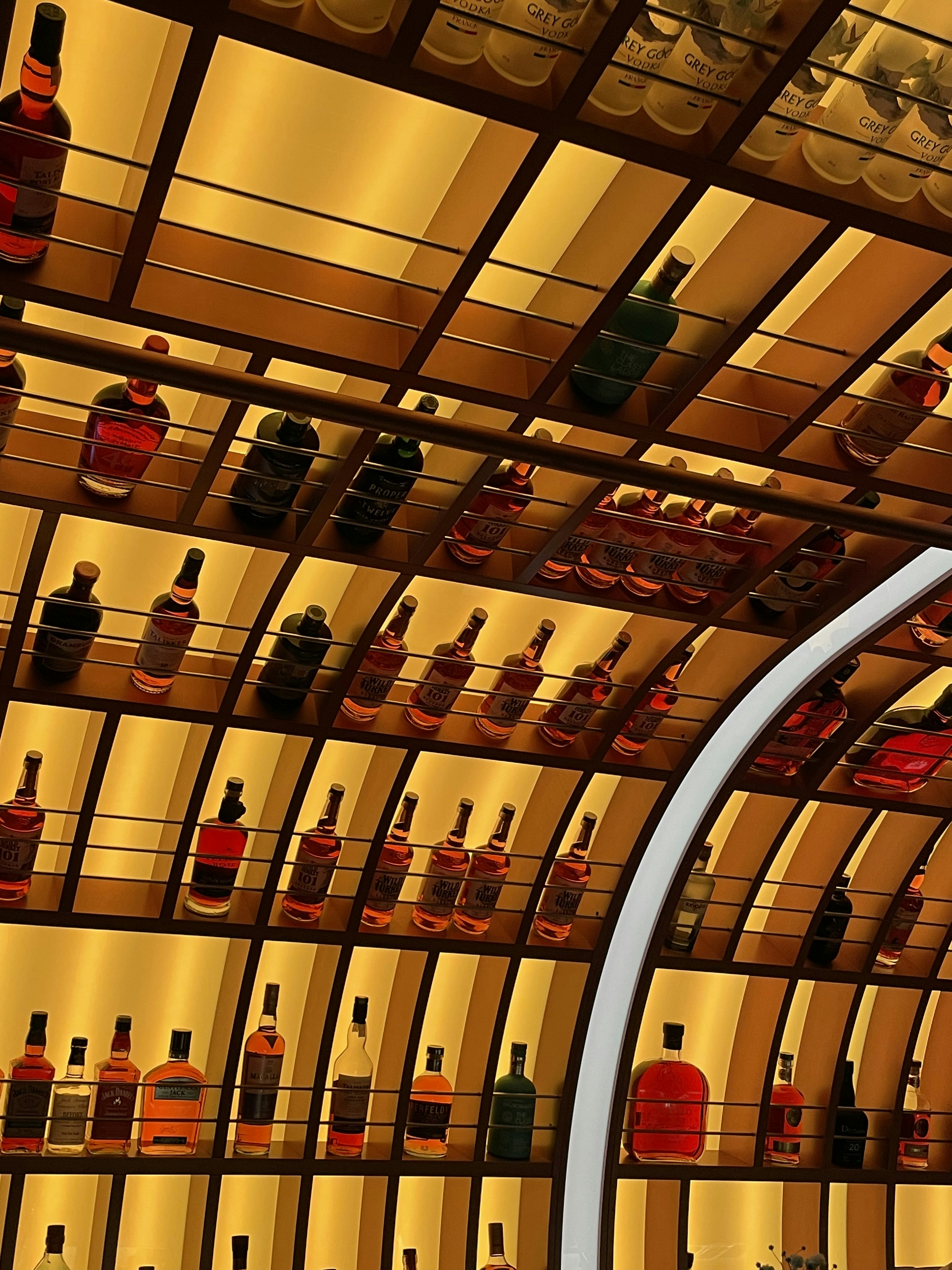 Backlit premium spirits bottles on a bar shelf
