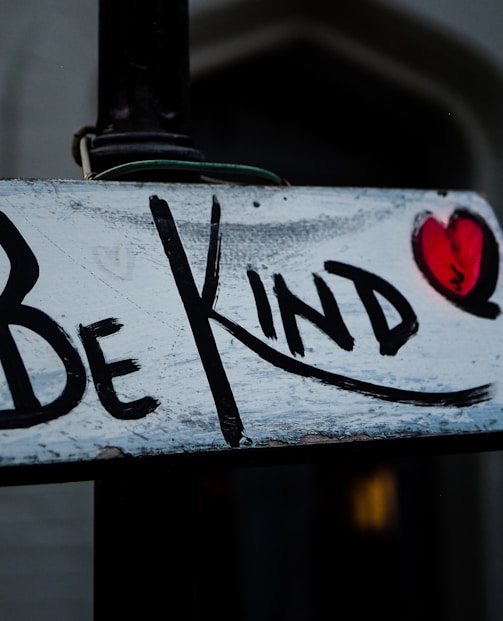 a sign that says be kind on it