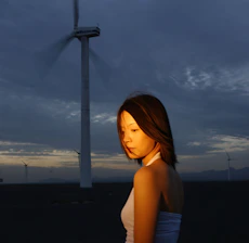 Portrait of Arley Lozano standing confidently in front of a sprawling renewable energy facility at dusk, with graphite and energy green lighting accents.