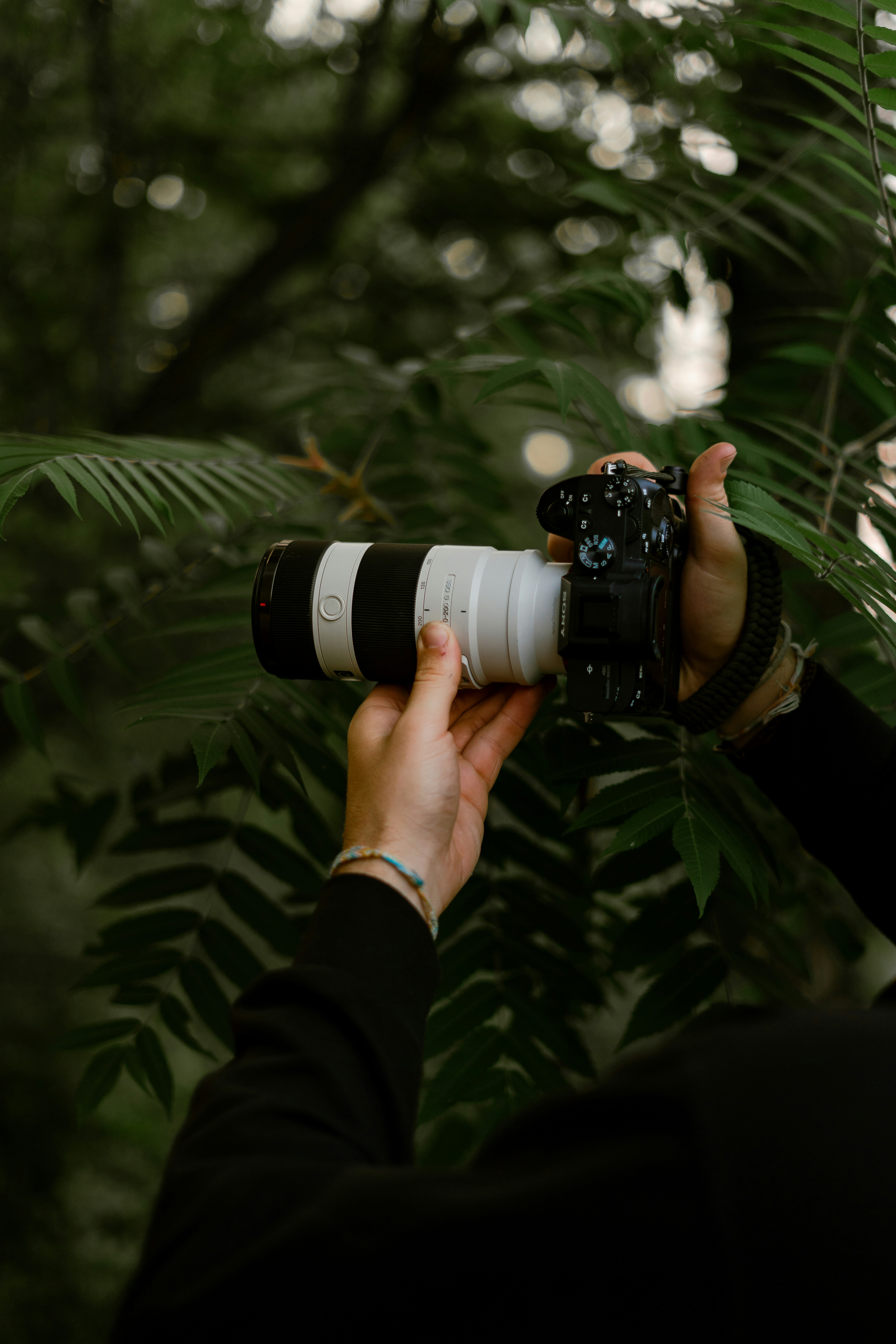 person holding black and white dslr camera