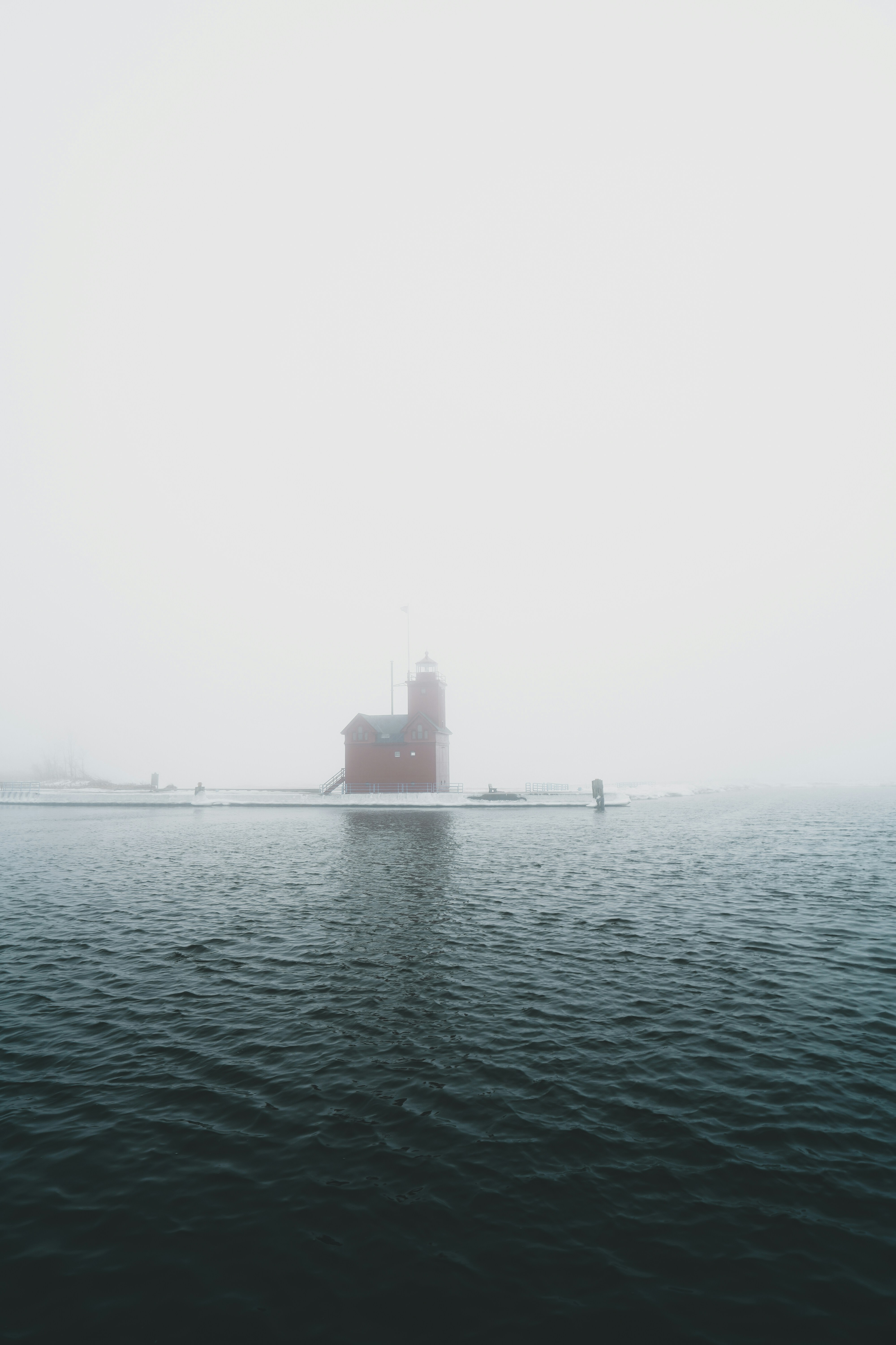 black ship on sea during foggy weather