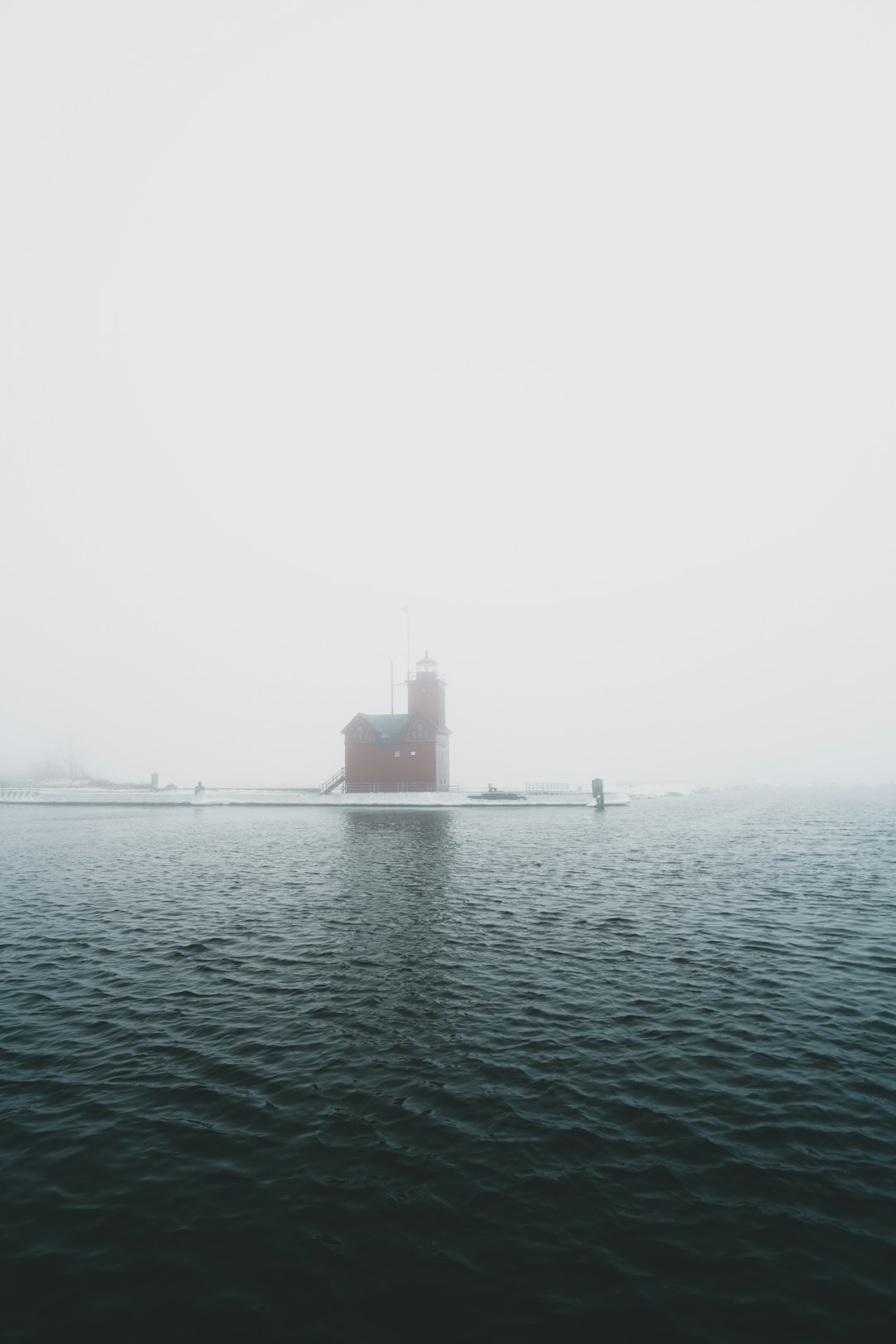 black ship on sea during foggy weather