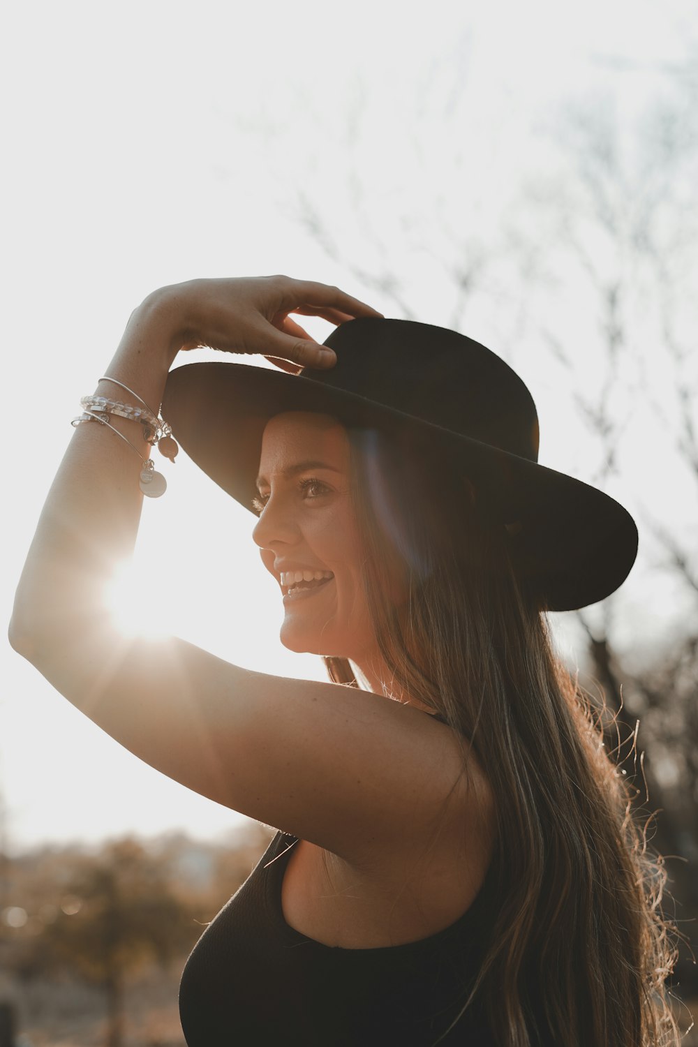 woman in black hat smiling