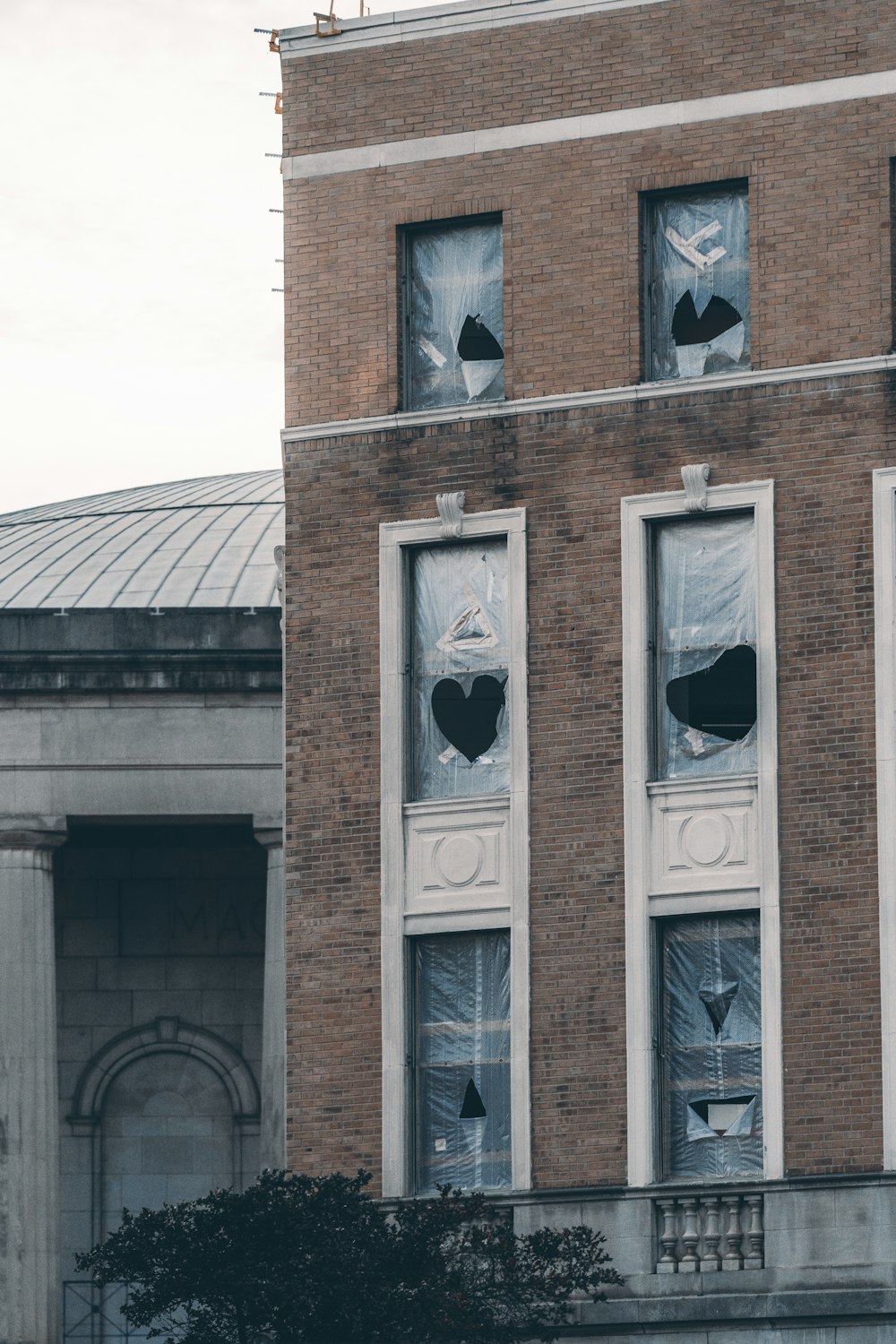 brown brick building with white wooden windows