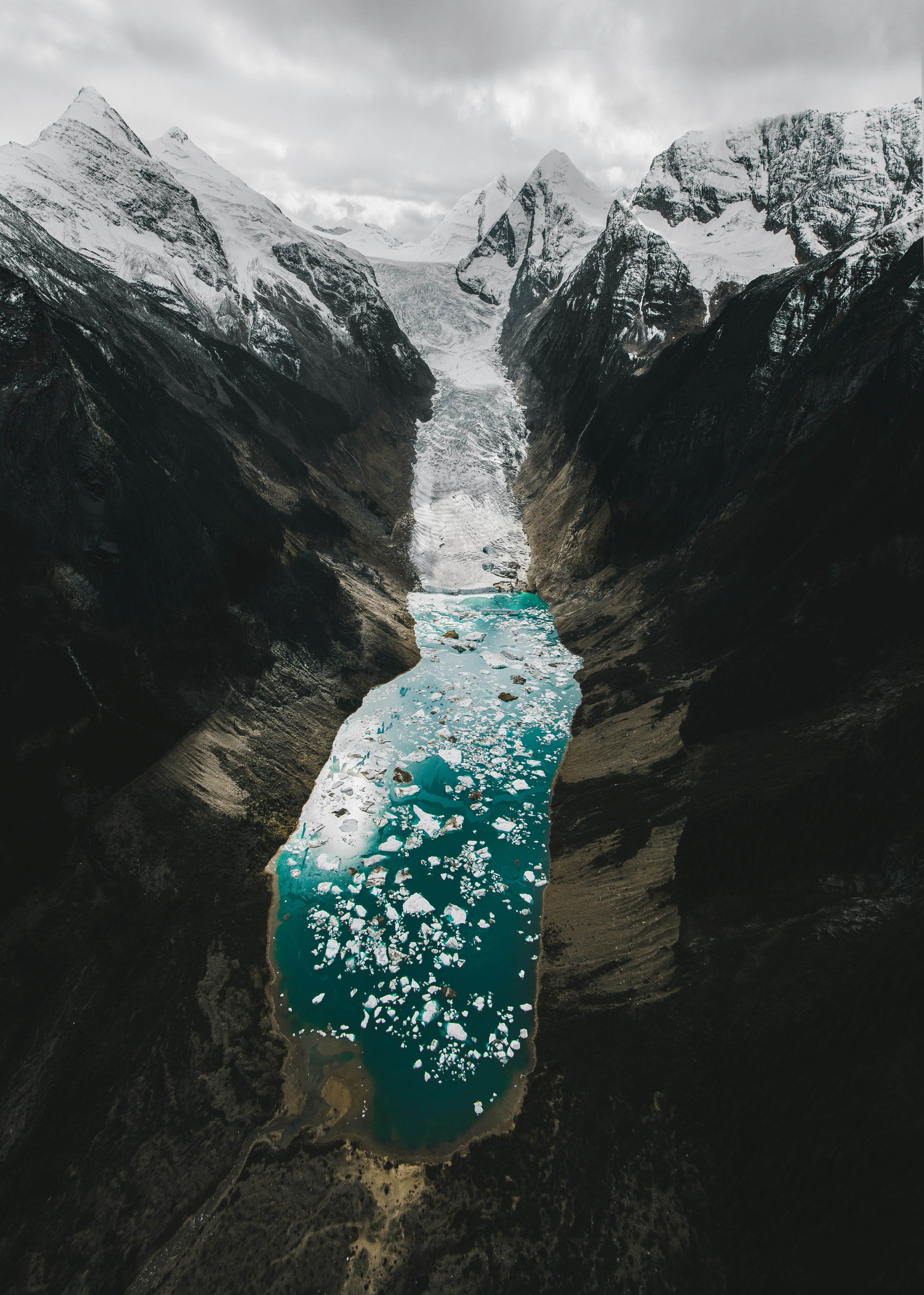 Person in blau-weißem Blumenkleid, die tagsüber auf einer Felsformation steht