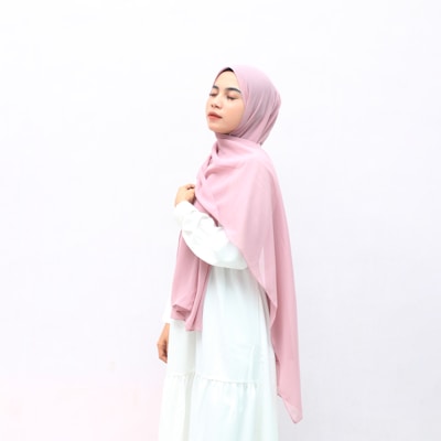 woman in pink hijab and white long sleeve dress