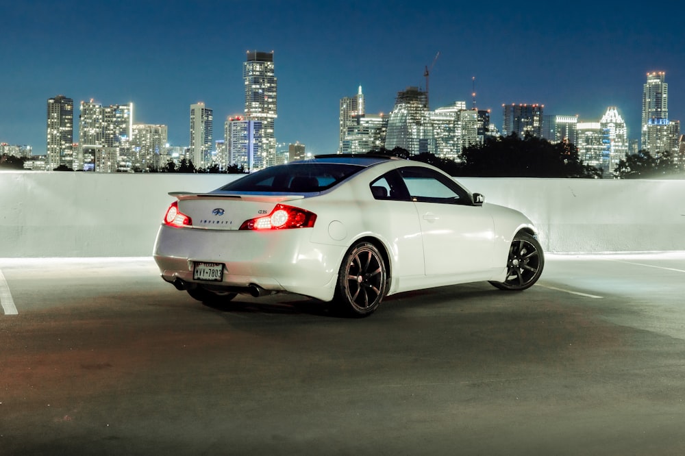 white porsche 911 parked on gray pavement during night time