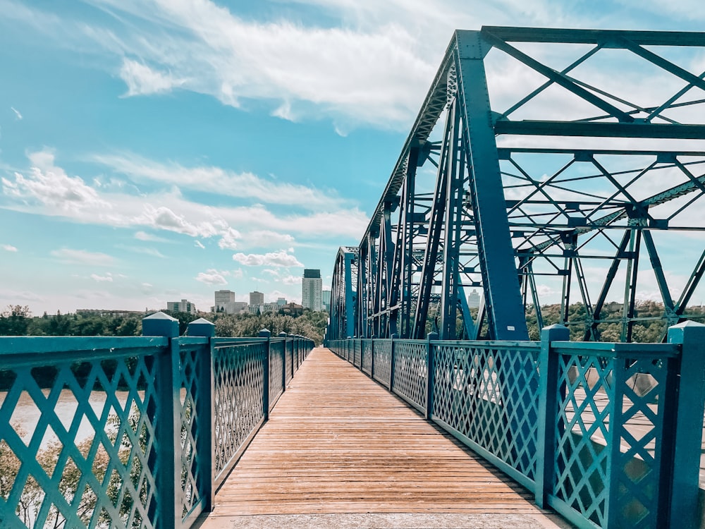 brown wooden bridge under blue sky during daytime