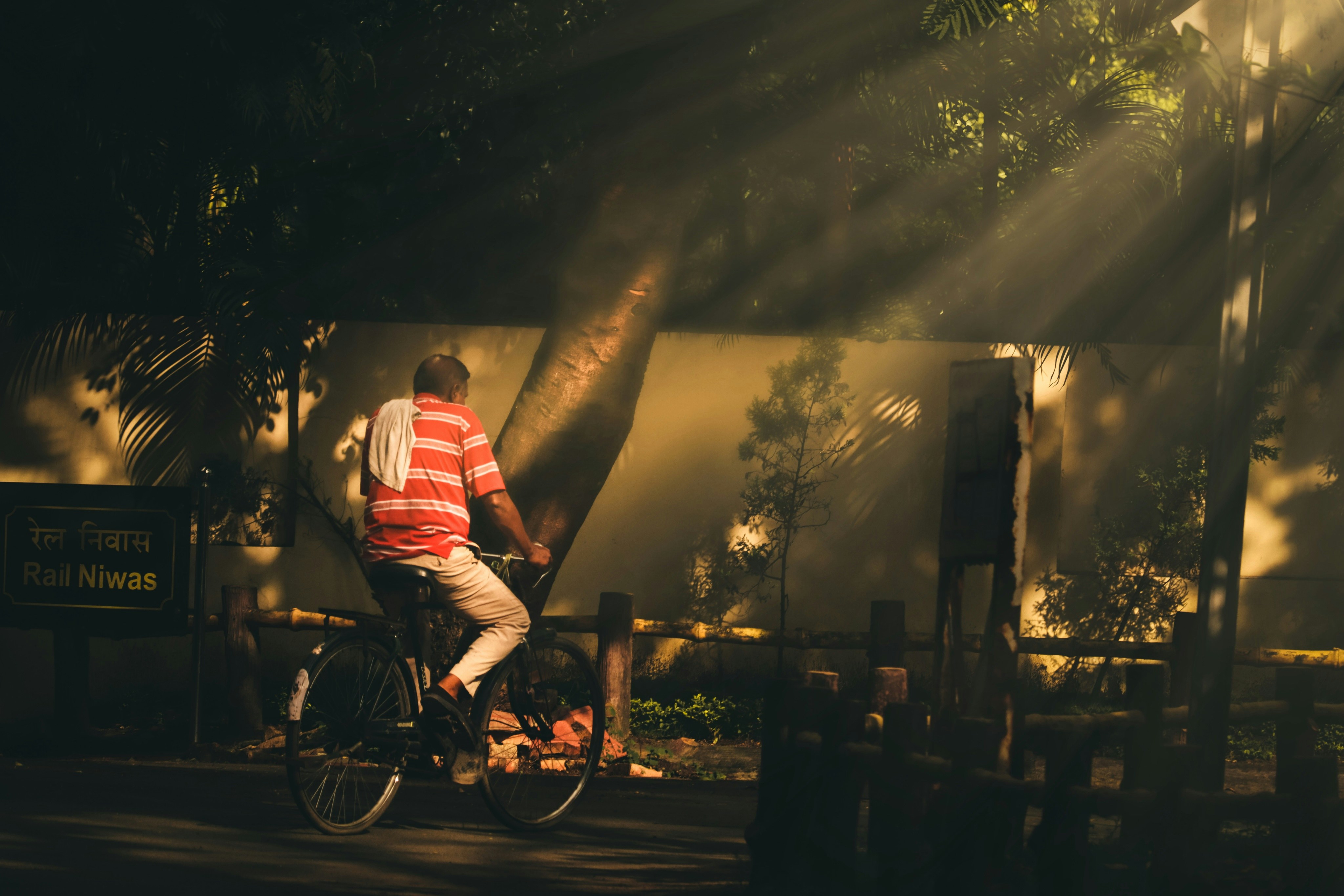 man in red shirt riding on bicycle during night time