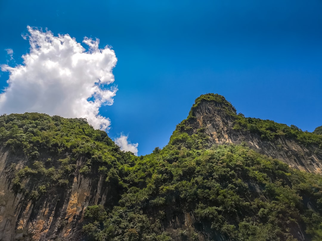 green and brown mountain under blue sky and white clouds during daytime