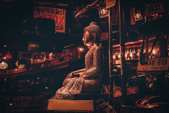 A dynamic animated image showcasing various revered Thai amulets and Buddha statues glowing softly.