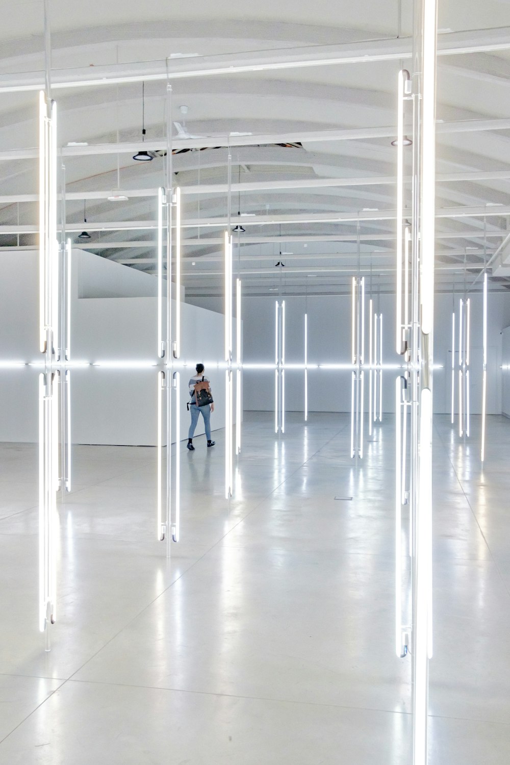 woman in white shirt standing on white floor