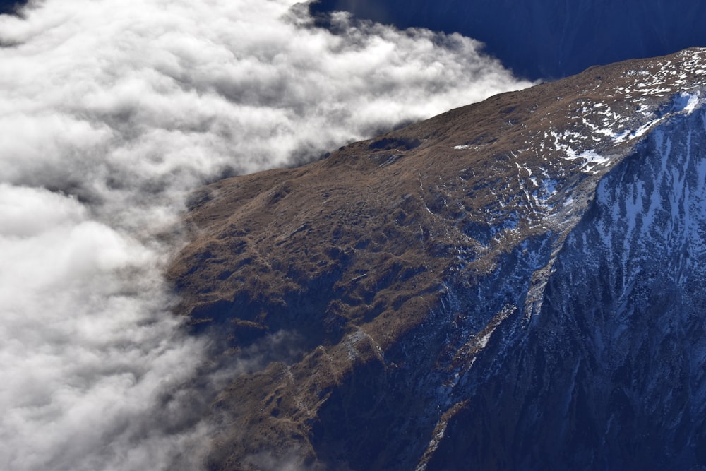 brown and green mountain under white clouds and blue sky during daytime