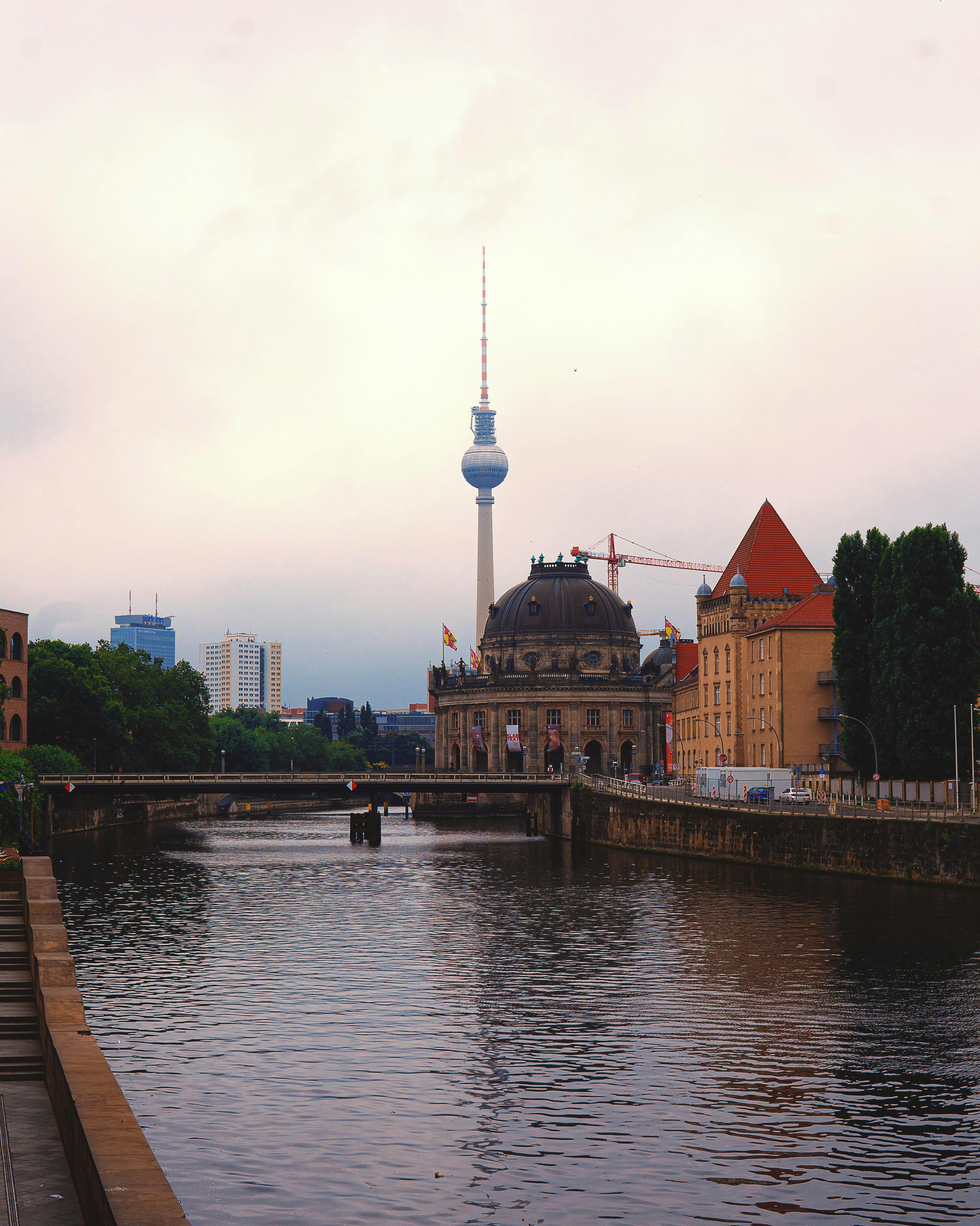 brown and white concrete building near body of water during daytime