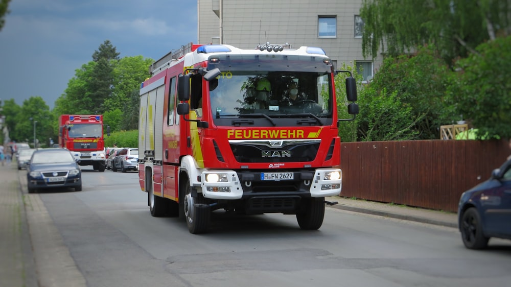 red and white fire truck on road during daytime