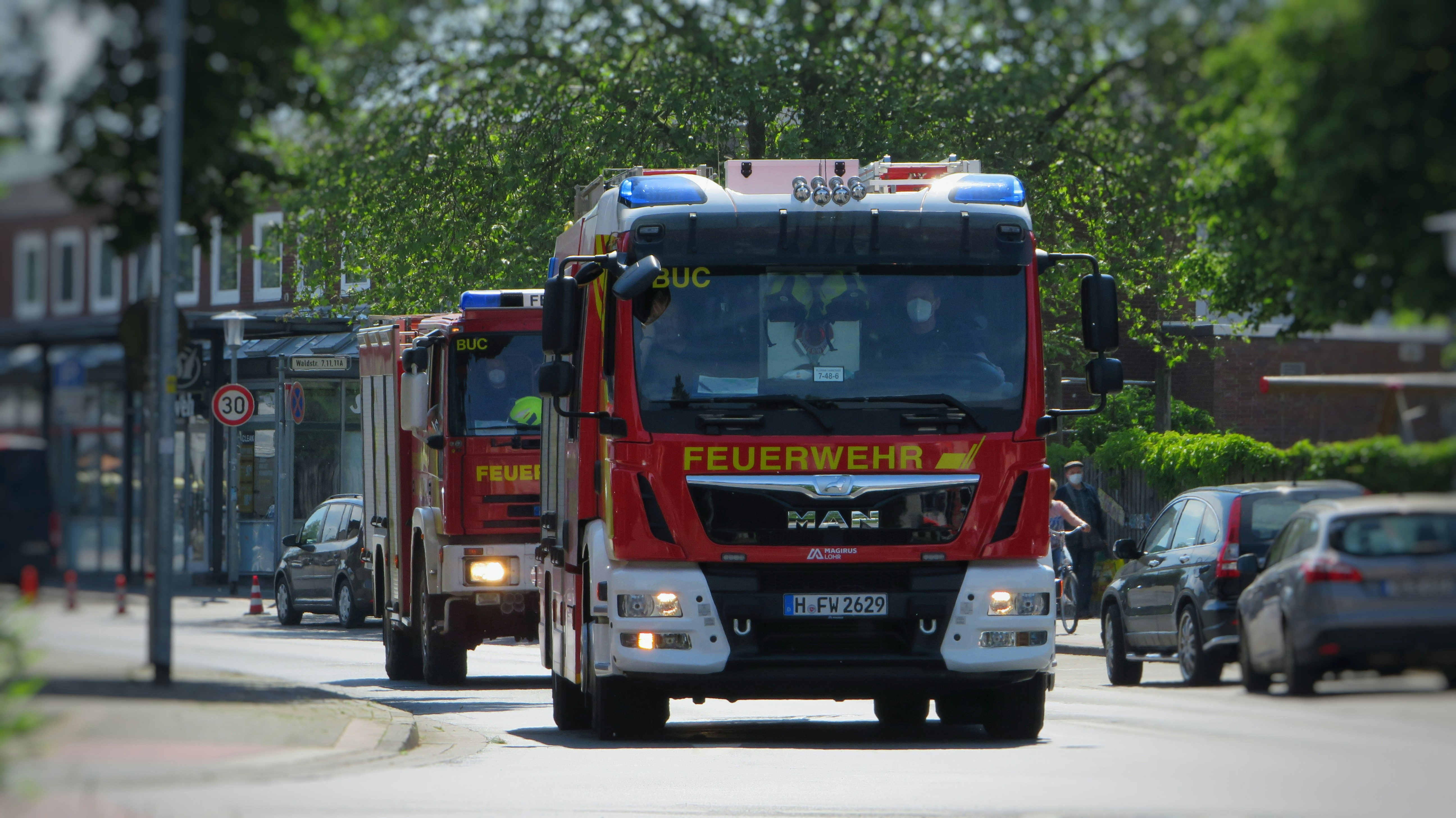 red and white truck on road during daytime