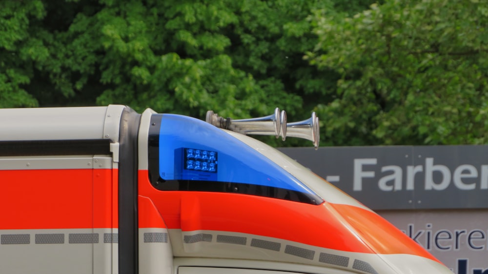 blue and red train on track during daytime